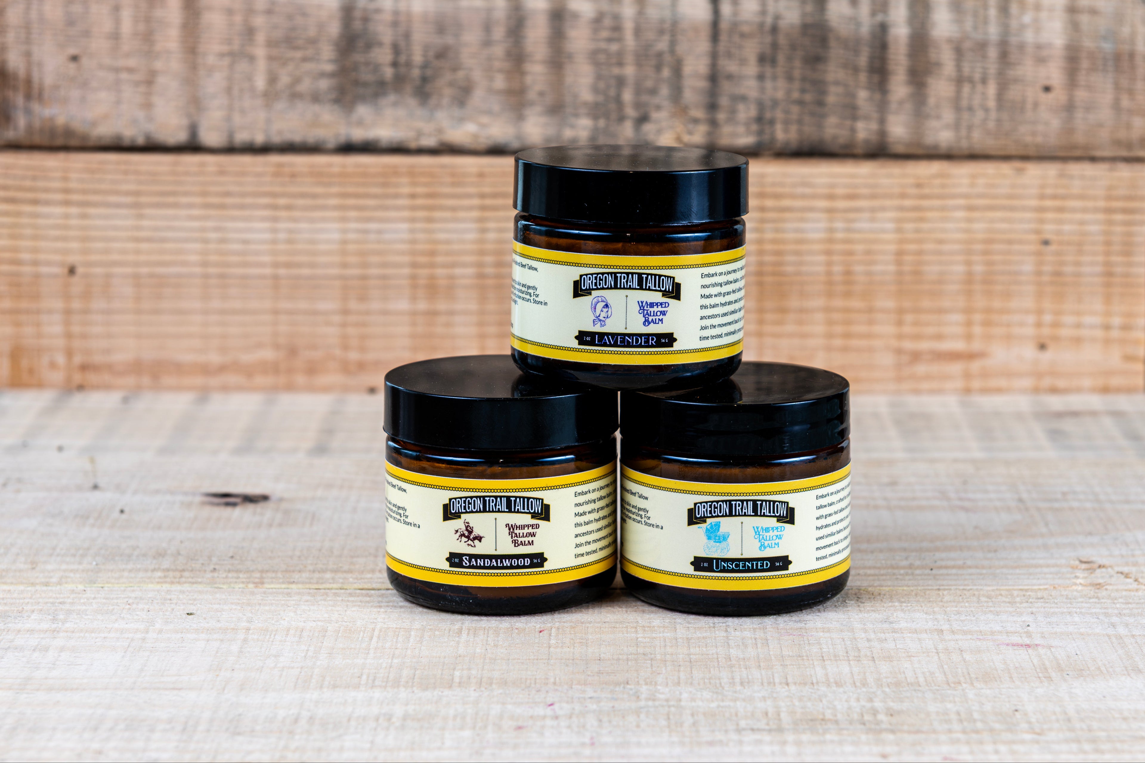 Three jars of a product with a label on a wooden surface